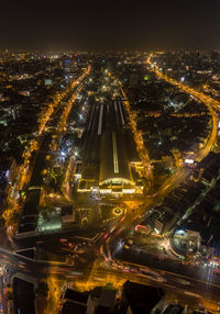 High angle view of city lit up at night
