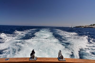 Close-up of boat in sea against clear sky