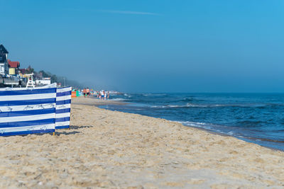 Bbeach screen on the polish beach on a sunny summer day in the background beautiful sea.