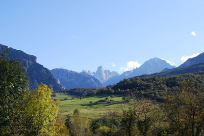 Scenic view of mountains against clear blue sky