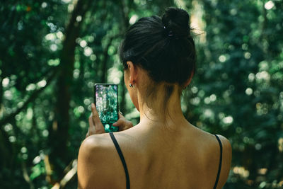 Rear view of woman in forest