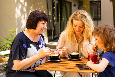 Women sitting on table at cafe