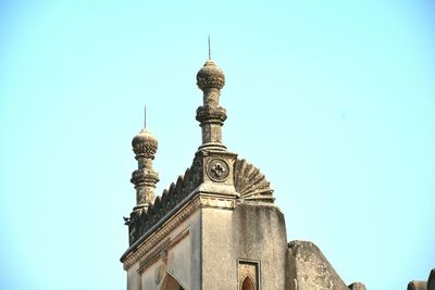 Low angle view of clock against clear sky