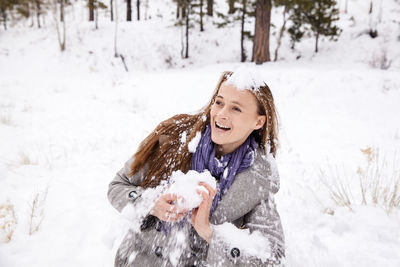 Woman with dog in snow