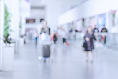 Blurred motion of people walking on road in city