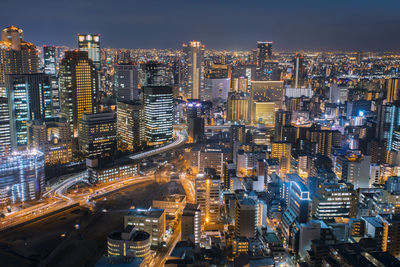 High angle view of illuminated city buildings at night