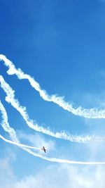 Low angle view of airplane flying against sky during airshow