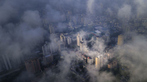 High angle view of smoke emitting from buildings in city