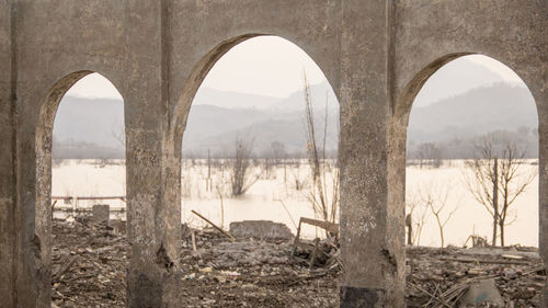 View of old landscape seen through arch window