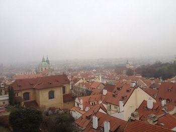 Houses in town against sky in city