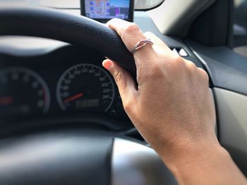 Cropped image of hand driving car