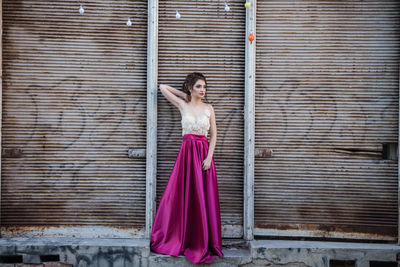 Woman standing against wall