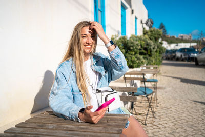 Portrait of young woman using mobile phone
