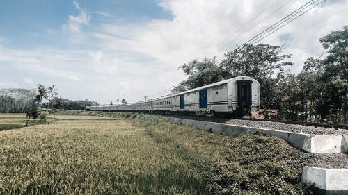 Train on field against sky