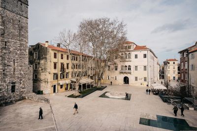 Street amidst buildings in city against sky