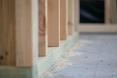 Residential construction site with concrete slab and wood studs 