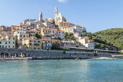  the beach of cervo with his beautiful historic center in background