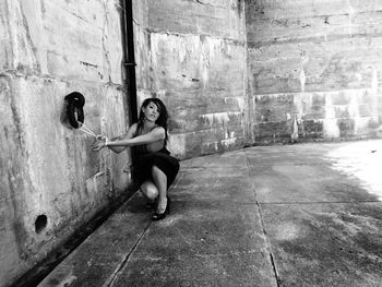 Full length of young woman captive against a historic fort wall