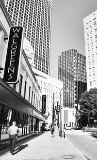 View of city street and buildings against sky