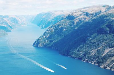 Aerial view of mountain by sea against sky