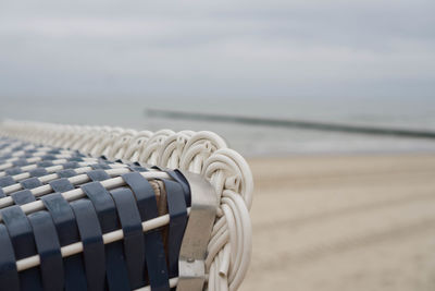 Close-up of sand at beach against sky