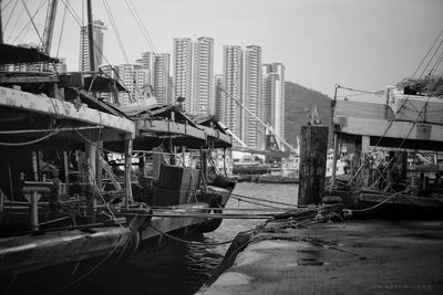 Boats moored in city against clear sky