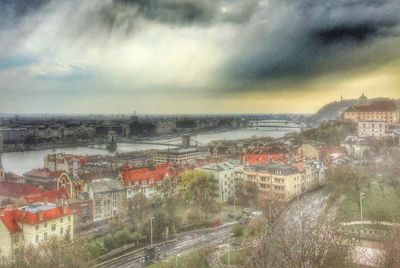 Cityscape against cloudy sky