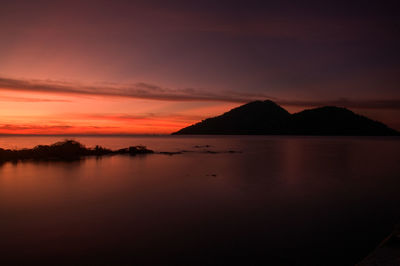 Scenic view of sea against romantic sky at sunset