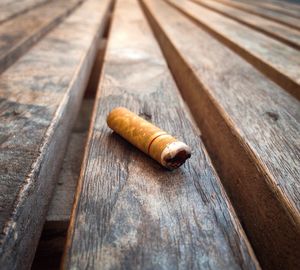 Close-up of cigarette on wood