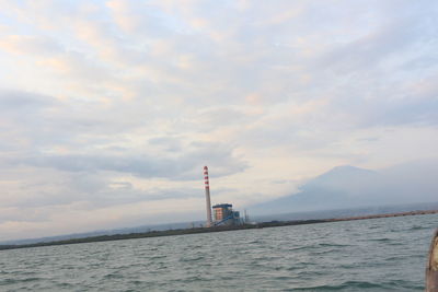 Scenic view of sea and buildings against sky