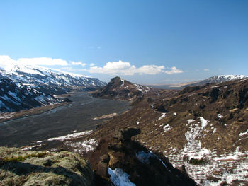 Snowcapped mountains with volcanic rocks and temporary water flows in thorsmork, iceland.