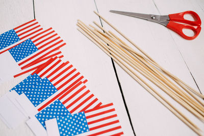 High angle view of american flags and sticks on table