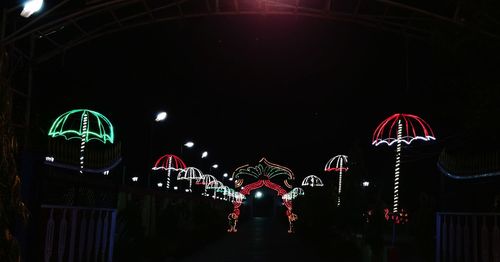 Illuminated ferris wheel at night