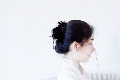 Side view of young woman over white background