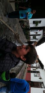 Boy looking away while sitting outdoors