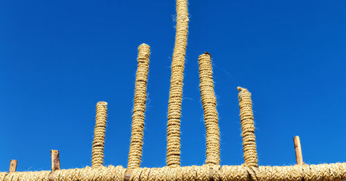 Low angle view of rope against blue sky