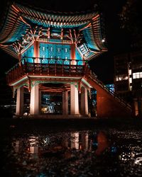 Low angle view of illuminated building at night