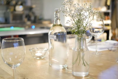 High angle view of bottle and vase on table at home