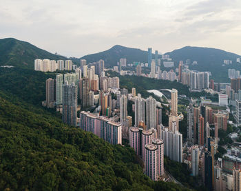 Aerial view of cityscape against mountains