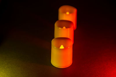 Close-up of illuminated lamp over black background