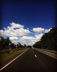 Empty road against cloudy sky