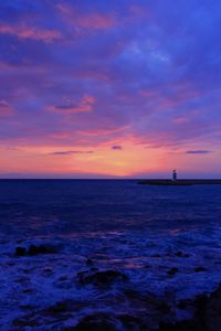 Scenic view of sea against sky at sunset