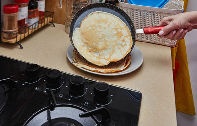 Cropped hand of person preparing food