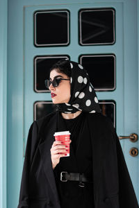 Portrait of young woman wearing sunglasses