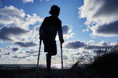 Rear view of man standing against sky