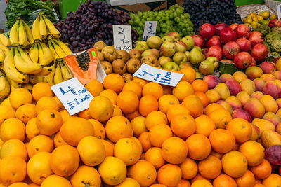 Piles of oranges and other fruits for sale at a market in london