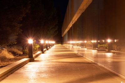 Illuminated street lights on footpath at night