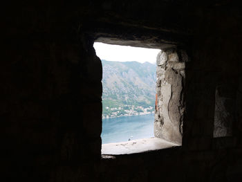 View of mountain seen through window