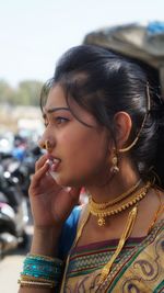 Close-up portrait of young woman looking away