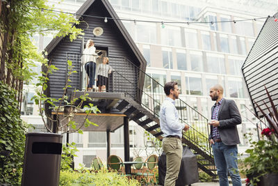 Business people discussing at office yard